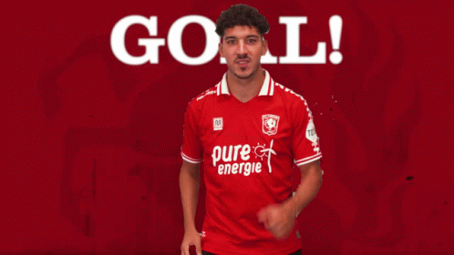 Soccer Player in Red Pure Energie Shirt Celebrates