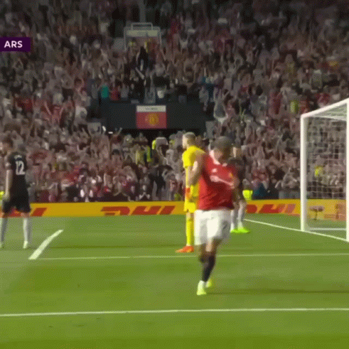 Soccer Player In Red Shirt Number 12 On Shorts