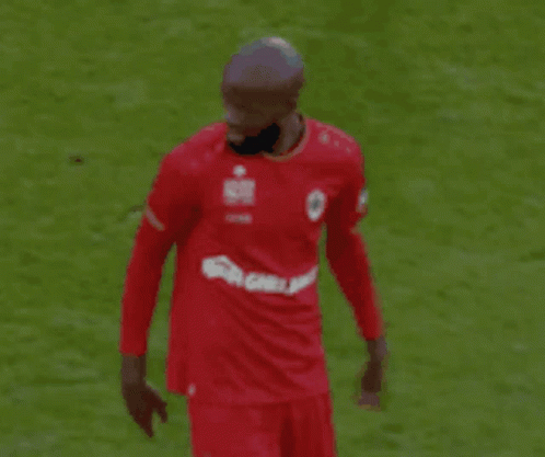 Soccer Player in Red Shirt Pointing at Field