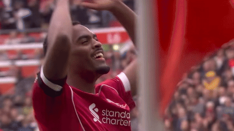 Soccer Player in Red Shirt Raising Arms