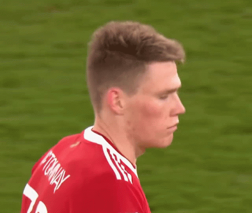 Soccer Player in Red Shirt With White Stripes
