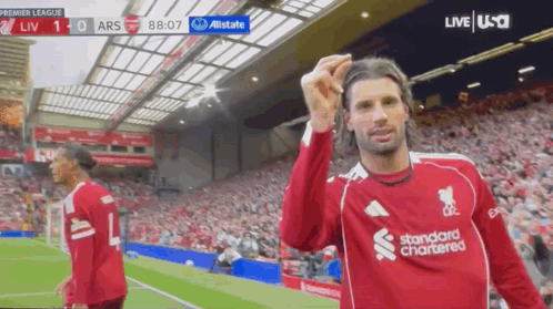 Soccer Player In Red Standard Chartered Jersey Celebrates Goal GIF