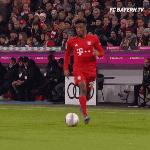 Soccer Player in Red T-Mobile Jersey Kicks Ball
