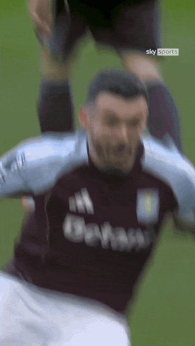 Soccer Player in Sky Sports Shirt Being Tackled