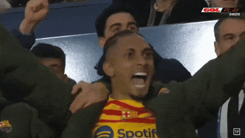 Soccer Player In Spotify Shirt Celebrating With Teammates GIF