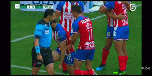 Soccer Player In Tecate Jersey Being Helped Off Field GIF