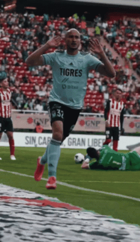 Soccer Player in Tigres Shirt Jumping