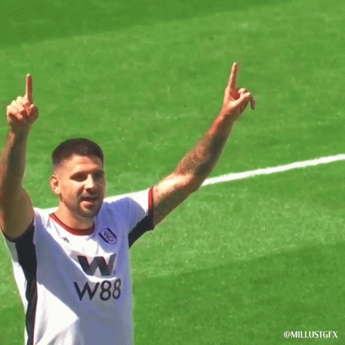Soccer Player In W88 Jersey Holding Up Arms GIF