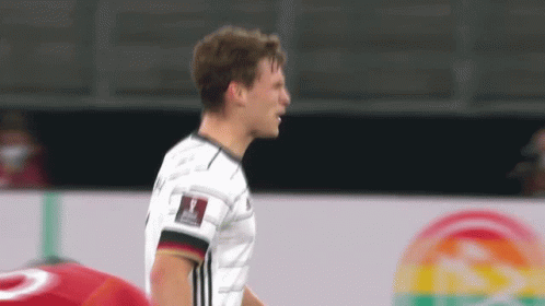 Soccer Player in White Adidas Jersey on Soccer Field