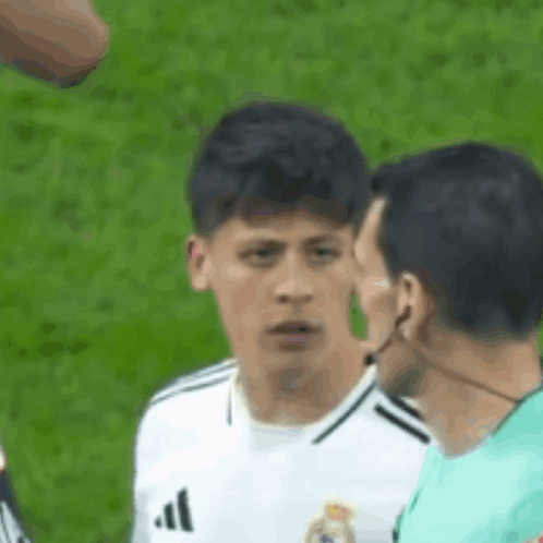 Soccer Player in White Adidas Jersey Talking to Umpire
