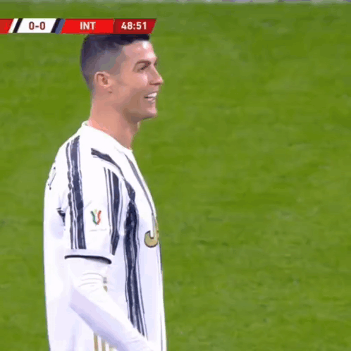 Soccer Player in White and Black Striped Jersey Smiling