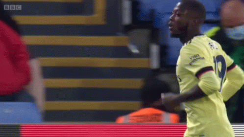 Soccer Player in Yellow Jersey Number 9 Running