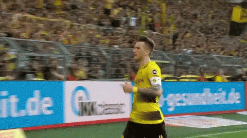 Soccer Player in Yellow Jersey Running with GK Sign