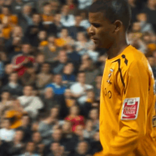 Soccer Player in Yellow Jersey With Coca-Cola Logo on Arm