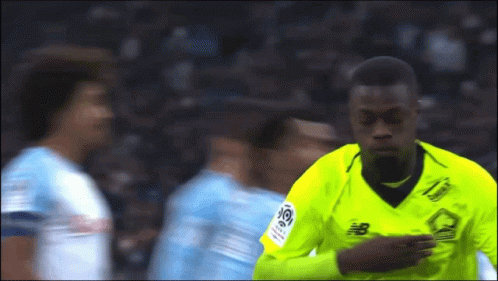 Soccer Player in Yellow Jersey With Letter B