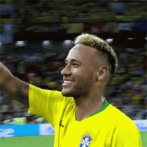 Soccer Player in Yellow Shirt Waving Smile