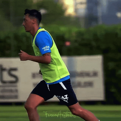 Soccer Player in Yellow Vest Saying nescafe.com