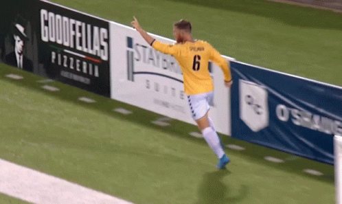 Soccer Player Jumping in Yellow Jersey Number 6