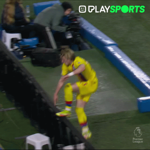 Soccer Player Jumping Over Fence