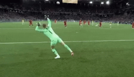Soccer Player Jumping to Catch Soccer Ball