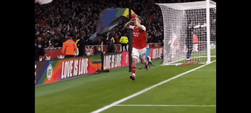 Soccer Player Jumping With Banner Love is Love