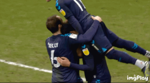 Soccer Player Kelly Jersey Lifted by Teammates
