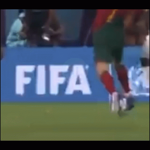 Soccer Player Kicking Ball at FIFA Sign