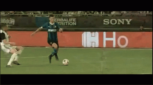 Soccer Player Kicking Ball in Front of Sony Sign