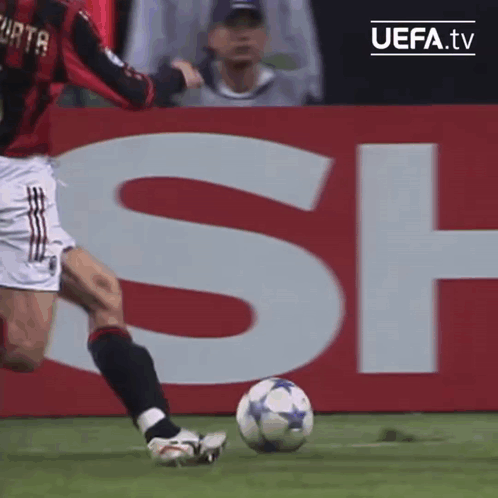 Soccer Player Kicking Ball In Front Of UEFA.tv Sign GIF