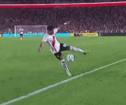 Soccer Player Kicking Ball on Field