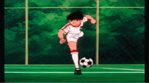 Soccer Player Kicking Ball on Field