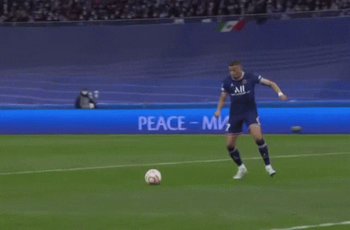 Soccer Player Kicks Ball at Peace Sign