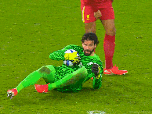 Soccer Player Kneeling Holding Ball