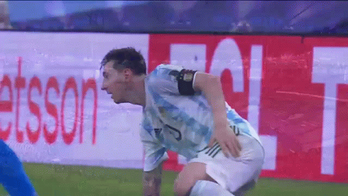 Soccer Player Kneeling in Front of Esson Sign