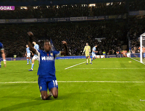 Soccer Player Kneeling on Field by Goal