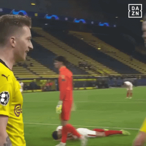 Soccer Player Laying Talking To Another With Onlooker GIF