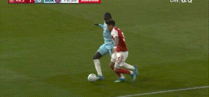 Soccer Player Lying As Another Kicks Ball GIF