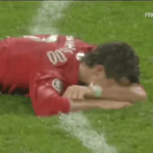 Soccer Player Lying on Field Head on Arms