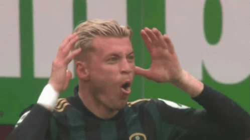 Soccer Player Making Funny Face in Green Jersey