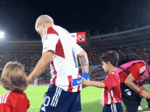 Soccer Player Number 10 Shaking Hands with Boy
