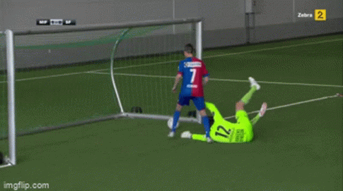 Soccer Player Number 12 Laying on Ground