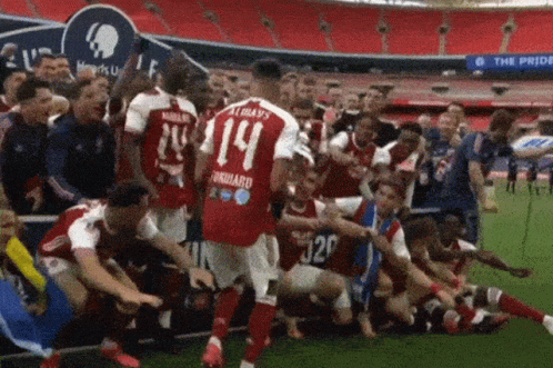 Soccer Player Number 14 Surrounded by Teammates