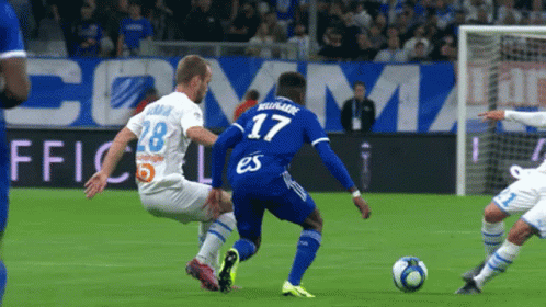 Soccer Player Number 17 Kicks Ball