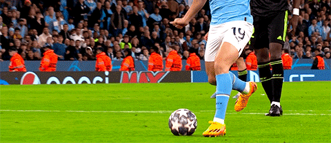 Soccer Player Number 19 Kicks Ball