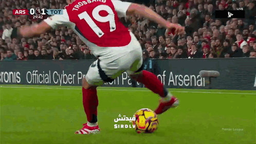 Soccer Player Number 19 Kicks Ball