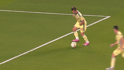 Soccer Player Number 25 Jumping to Catch Ball
