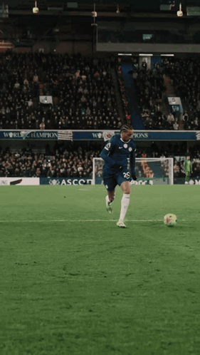 Soccer Player Number 26 Kicks Ball
