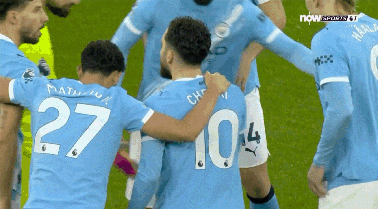 Soccer Player Number 27 Surrounded by Teammates
