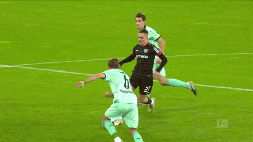 Soccer Player Number 6 Being Tackled
