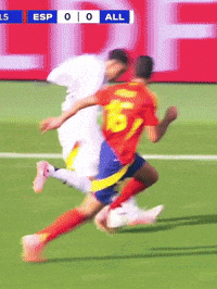 Soccer Player Number 6 Being Tackled
